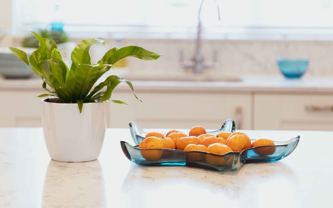 bowl of oranges and house plant in kitchen, decluttering